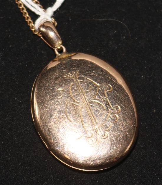 A gold oval locket on a 9ct chain.